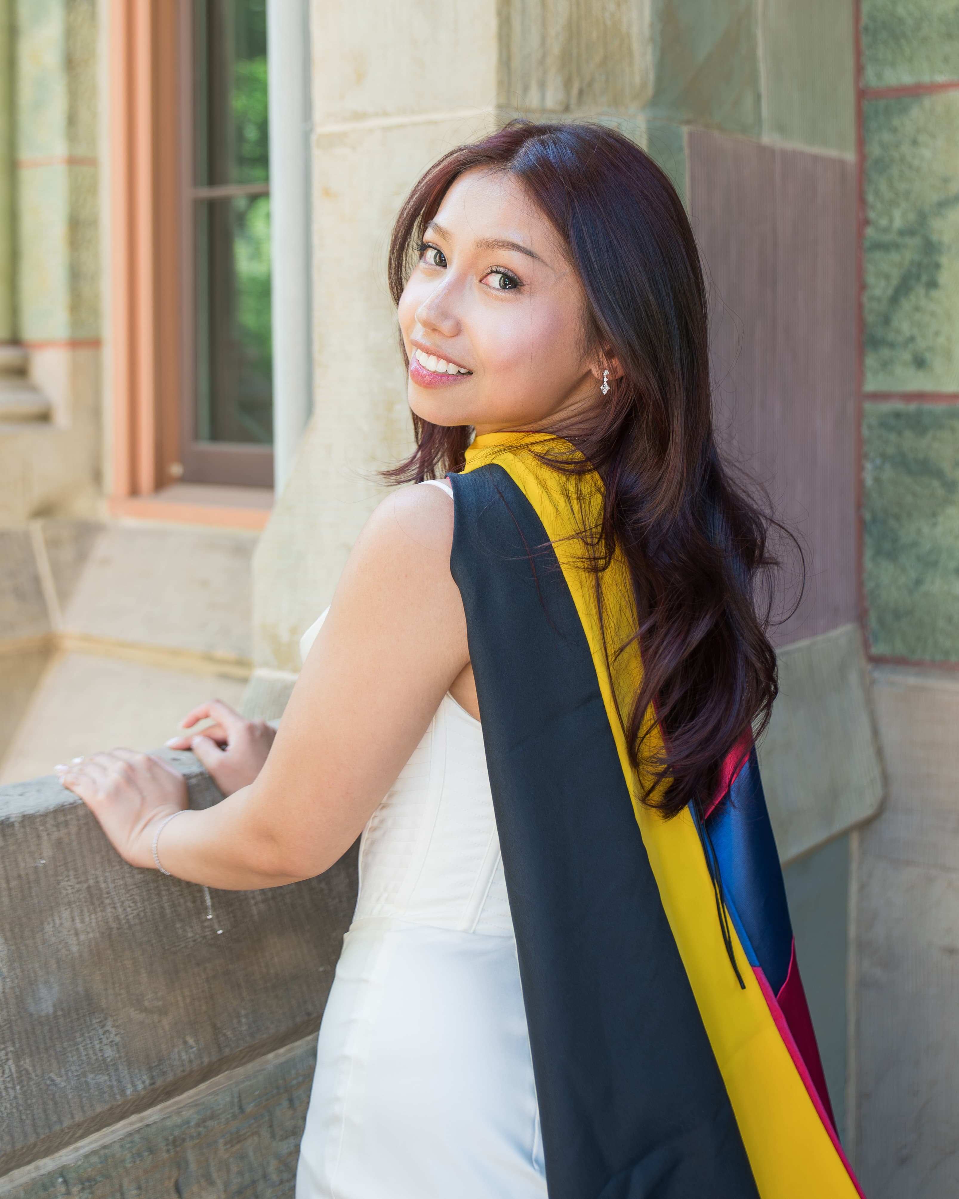 Johanna Momole wearing her Penn graduation stole on campus